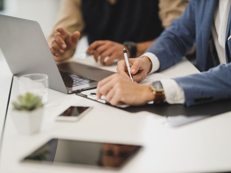 Two people discussing work at an office table