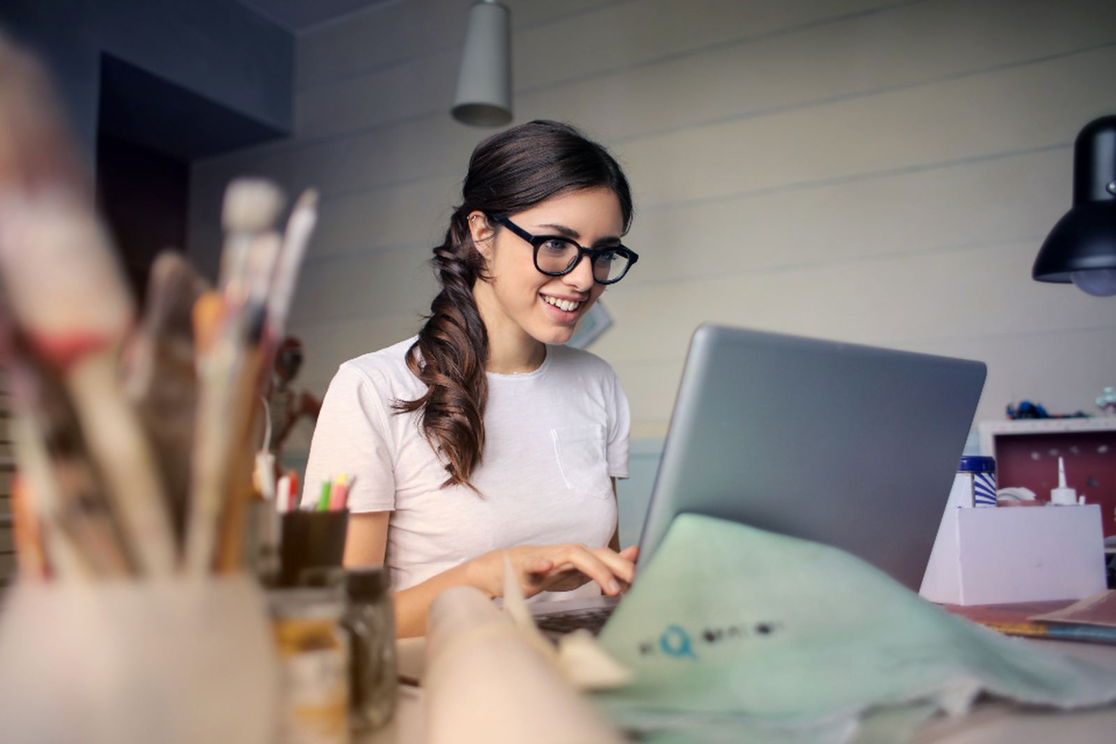 A person working at a laptop in a bright workspace