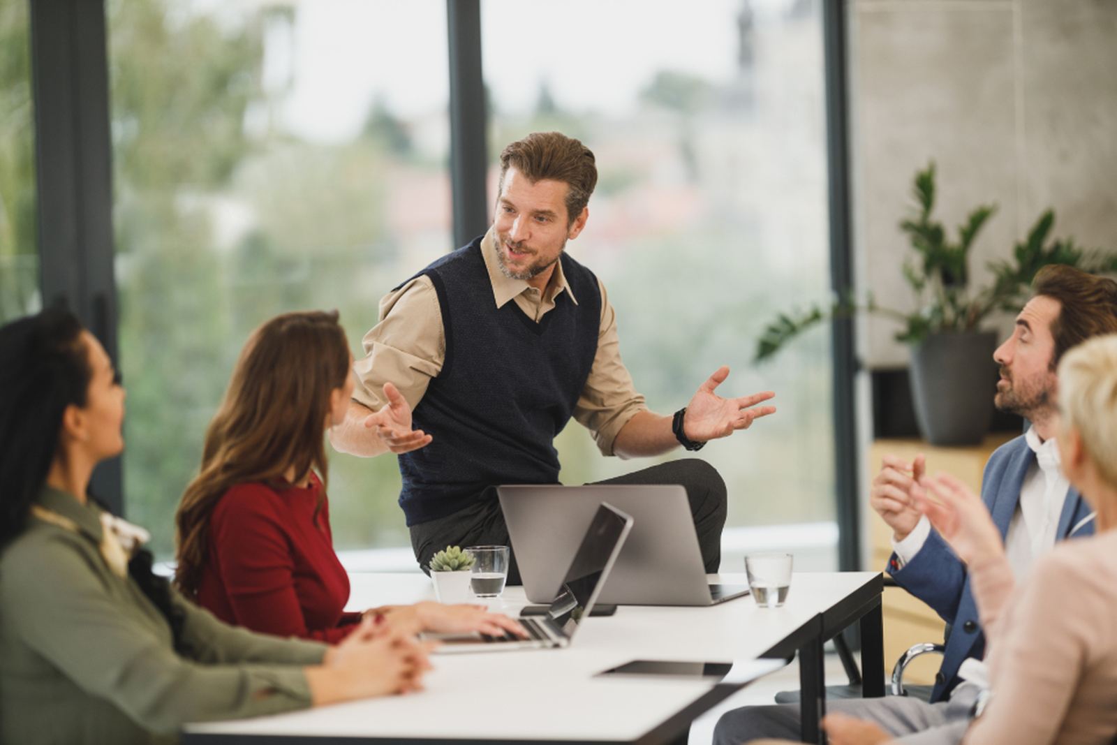 Colleagues working together around a table in an office