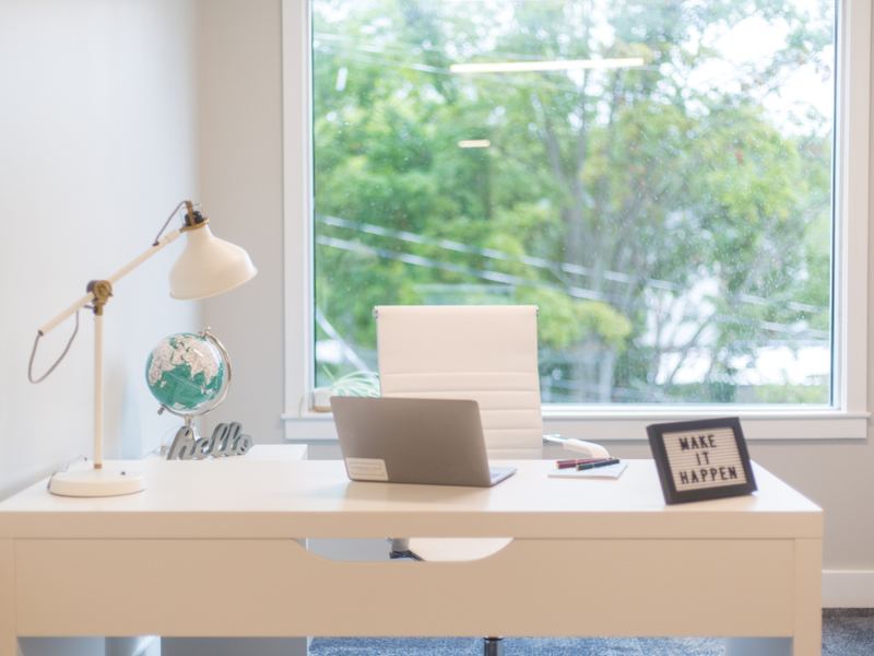 A bright home-office desk beside a window