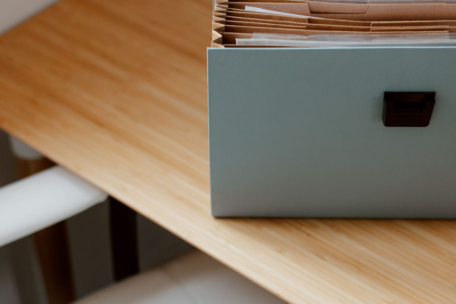 A document filing box on a desk in a bright, tidy office