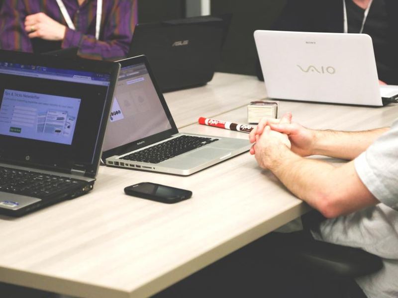 People reviewing work together on a laptop