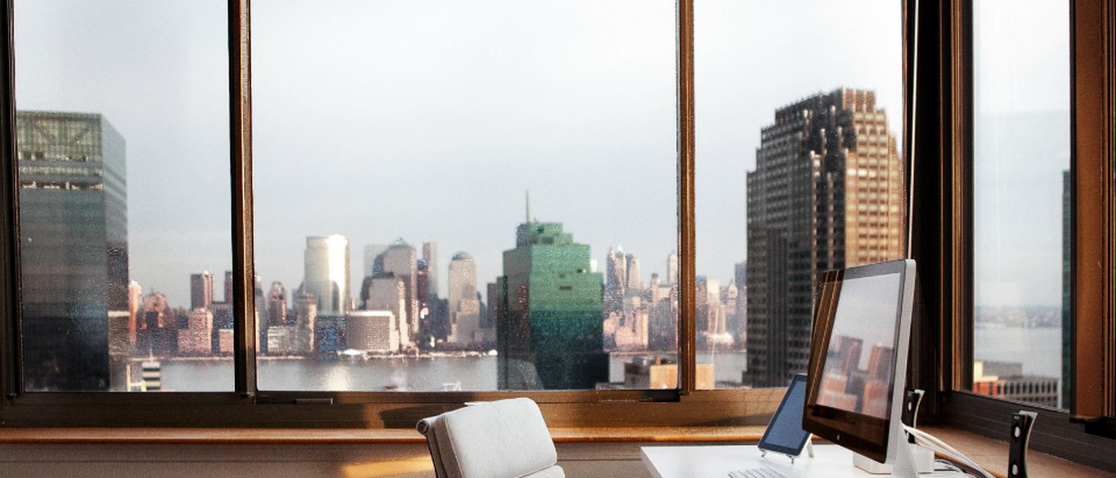 An office workspace beside a large window