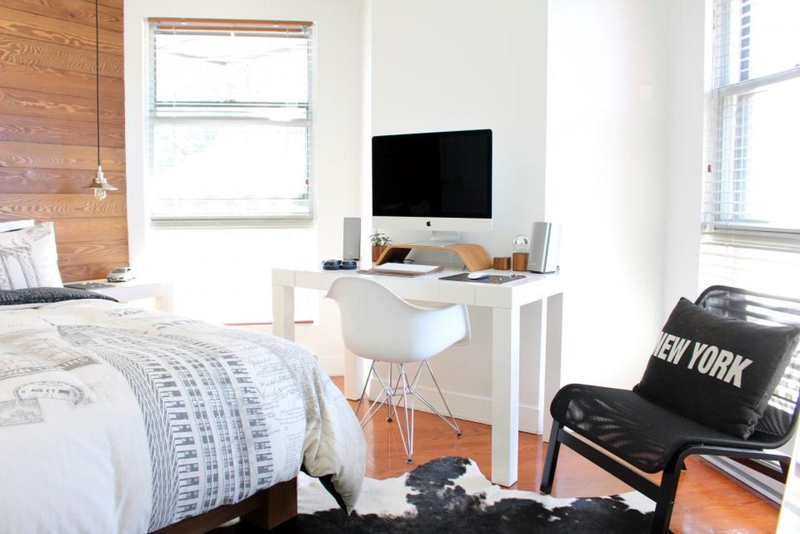 A home-office desk with a printer, monitor and chair