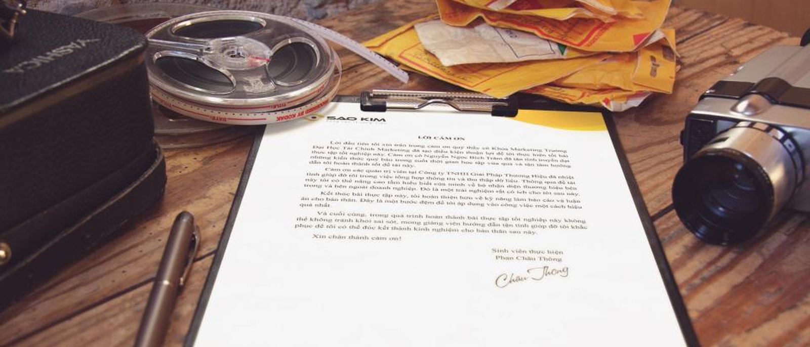 A printed document and a pen on a wooden desk