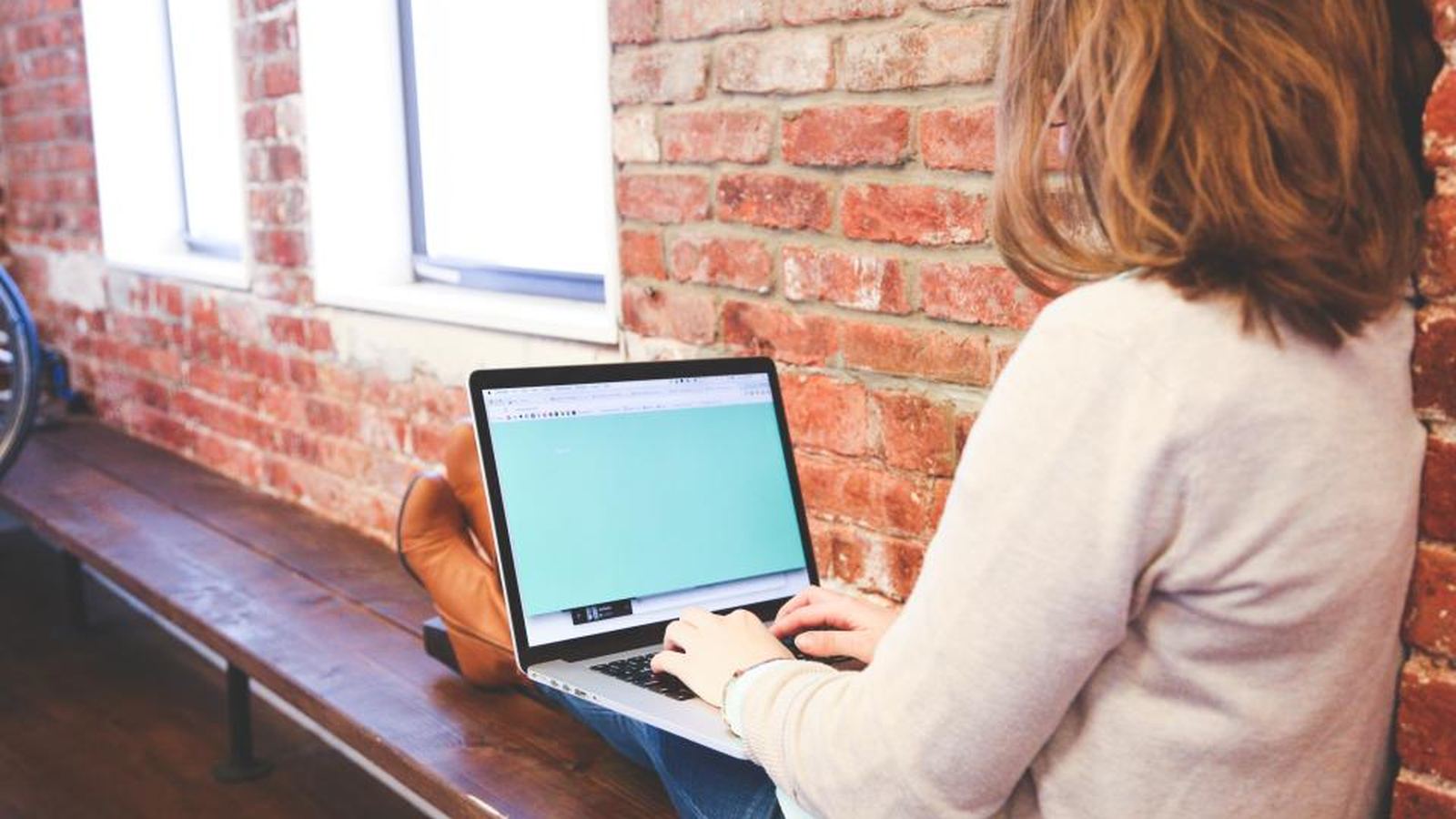 A person working on a laptop in a bright office