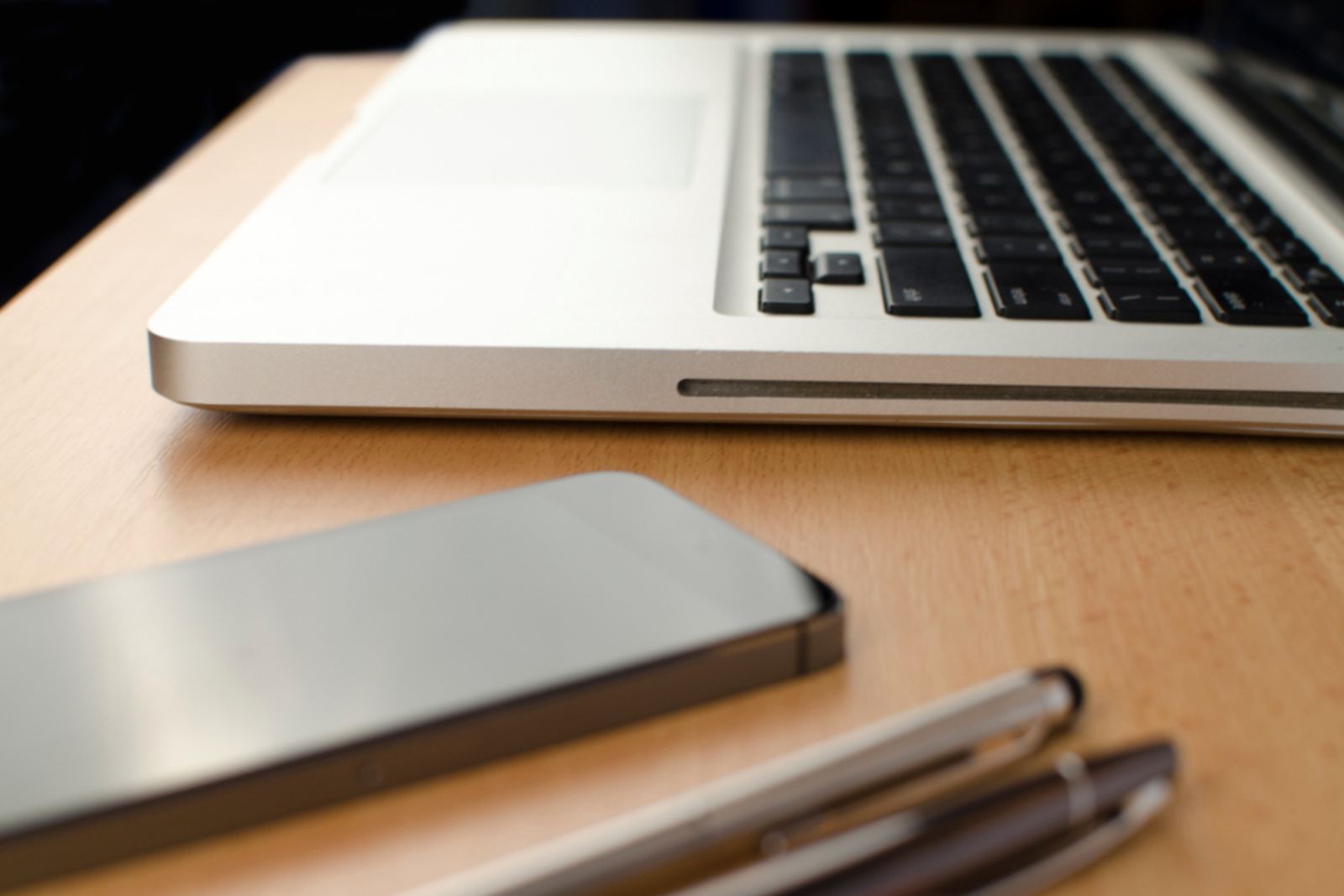 A closed laptop on a clean desk surface