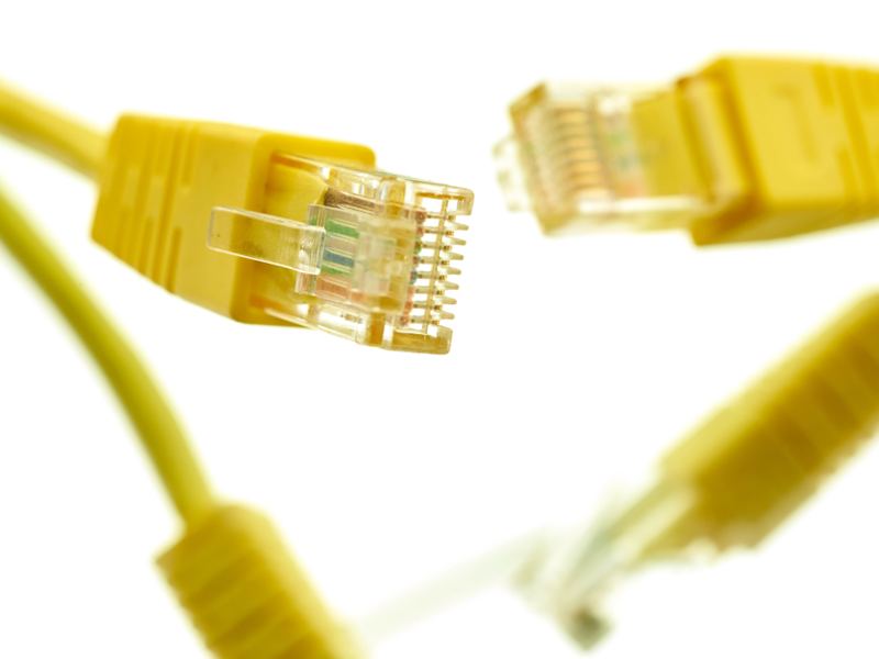 A yellow network cable connector against a dark background