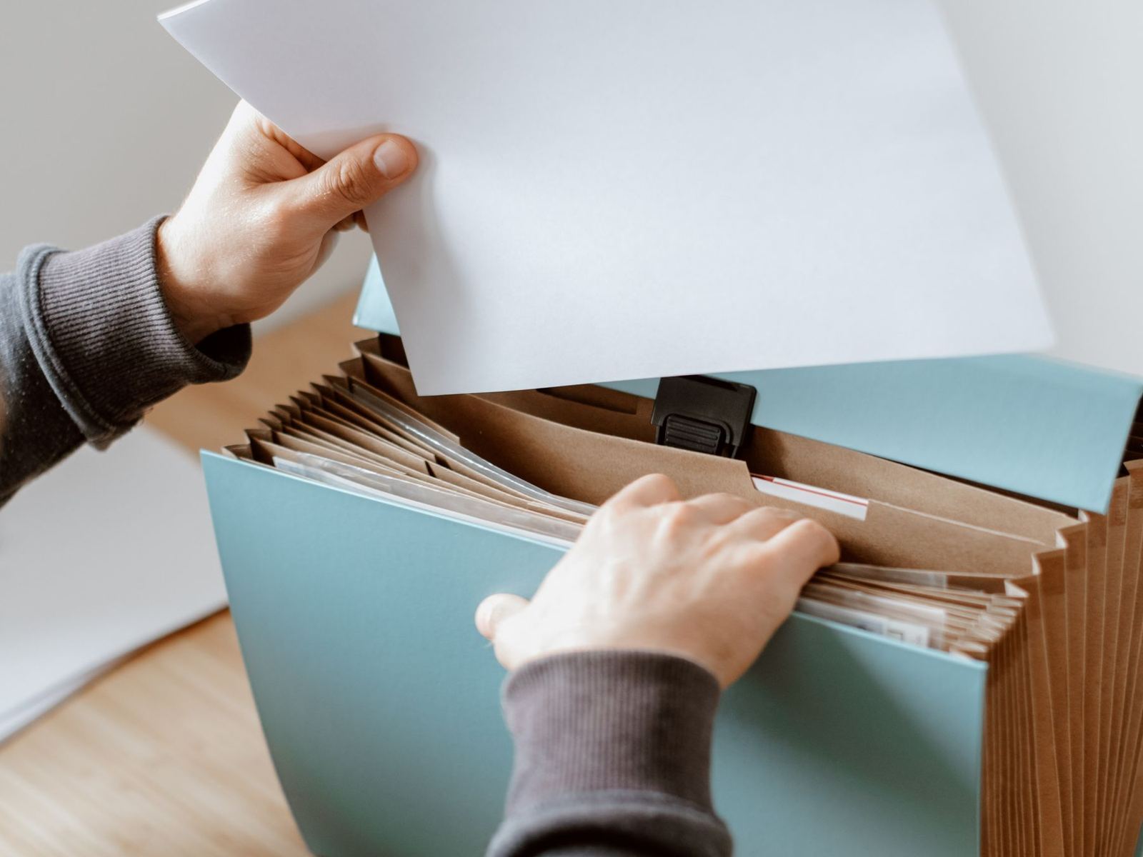 A printed page being lifted from a desktop document file