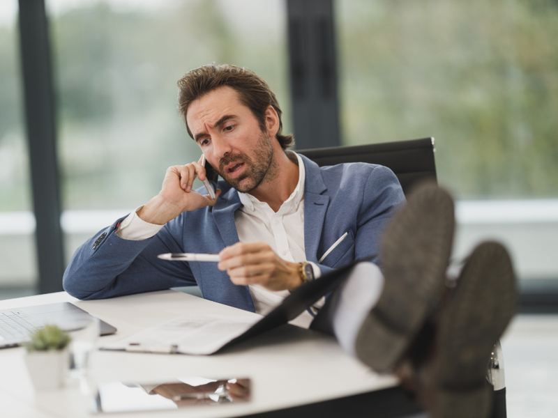A person taking a phone call at an office desk